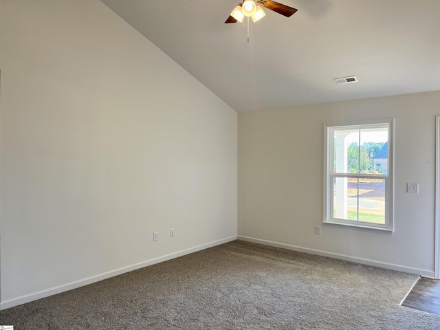 carpeted empty room featuring baseboards, visible vents, and a ceiling fan