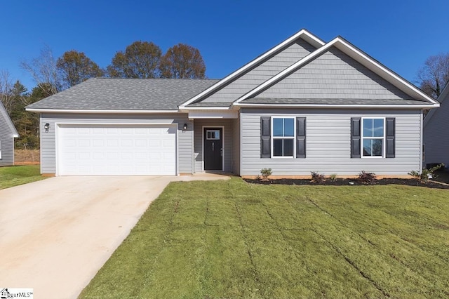 view of front of house featuring a garage, roof with shingles, concrete driveway, and a front yard