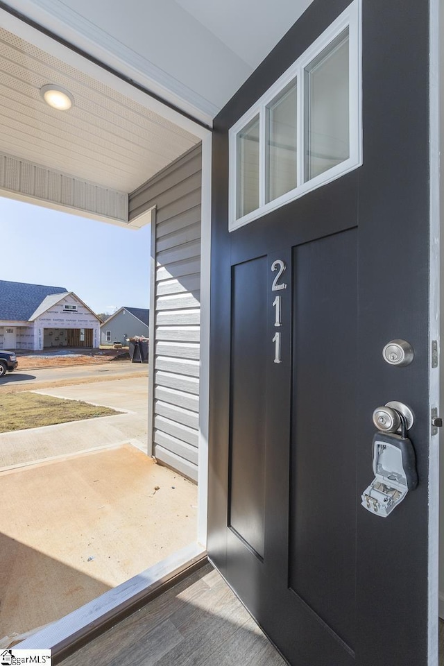 doorway to property featuring a residential view