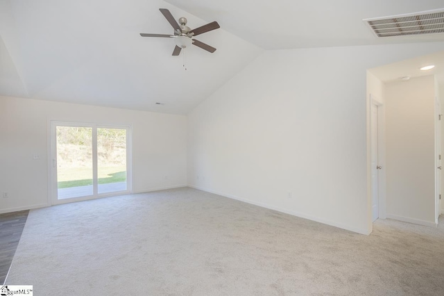 carpeted empty room with lofted ceiling, baseboards, visible vents, and ceiling fan