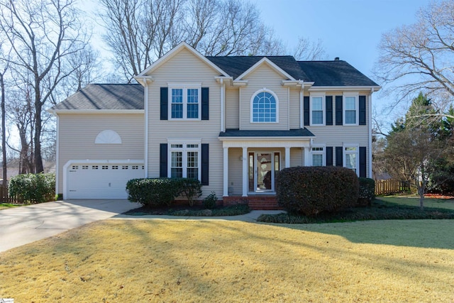 colonial-style house featuring driveway and a front lawn