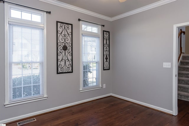 spare room with stairs, ornamental molding, dark wood-style floors, and visible vents