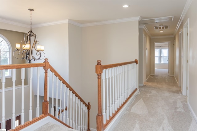 corridor featuring light colored carpet, crown molding, and an upstairs landing