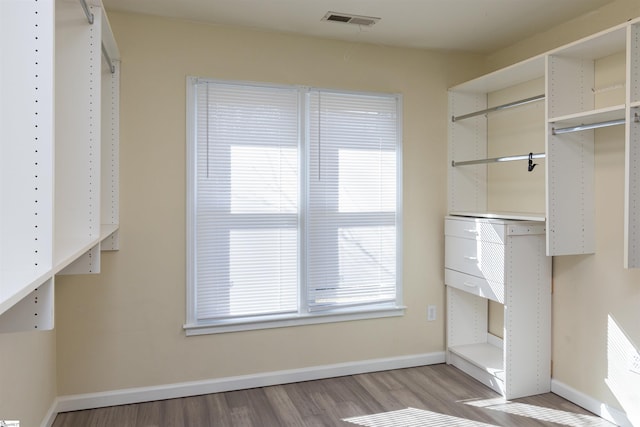 spacious closet featuring light wood-type flooring and visible vents