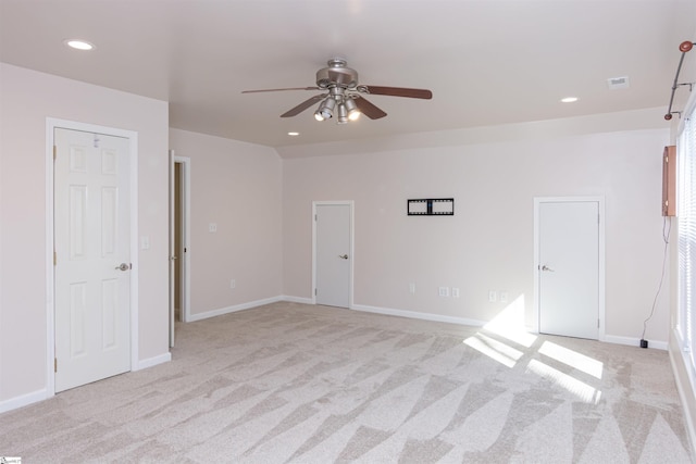 spare room with recessed lighting, light colored carpet, visible vents, ceiling fan, and baseboards