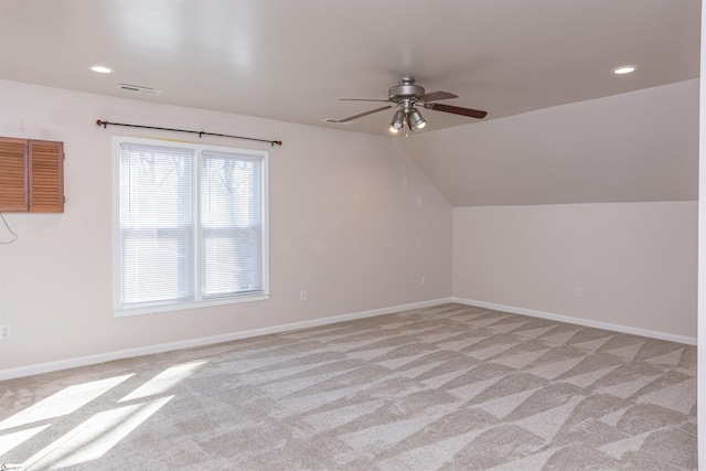 additional living space with baseboards, visible vents, vaulted ceiling, and recessed lighting