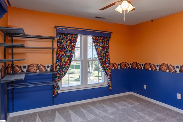 spare room featuring carpet floors, visible vents, plenty of natural light, and baseboards