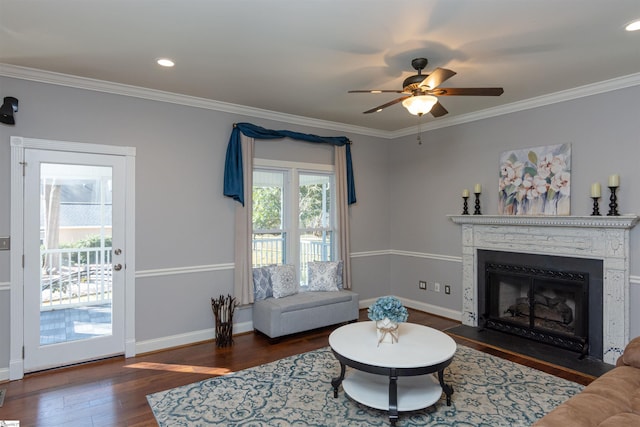 living area featuring a fireplace with flush hearth, dark wood-style flooring, a healthy amount of sunlight, and baseboards