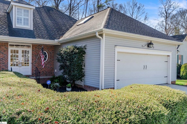 view of property exterior with an attached garage, driveway, a shingled roof, and brick siding