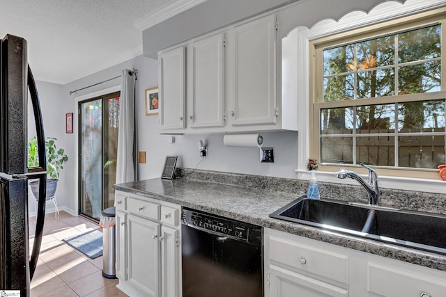 kitchen featuring light tile patterned floors, dark countertops, white cabinetry, a sink, and black appliances