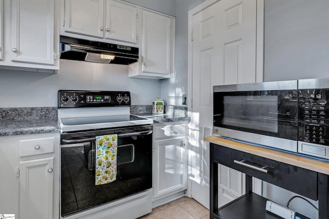 kitchen with electric range oven, light tile patterned floors, white cabinetry, and under cabinet range hood