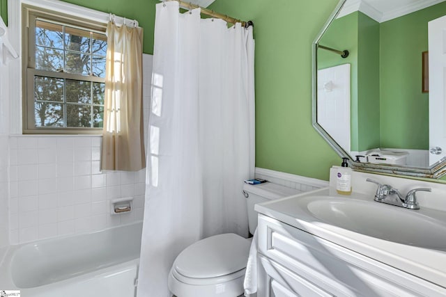 full bath featuring ornamental molding, shower / tub combo with curtain, vanity, and toilet