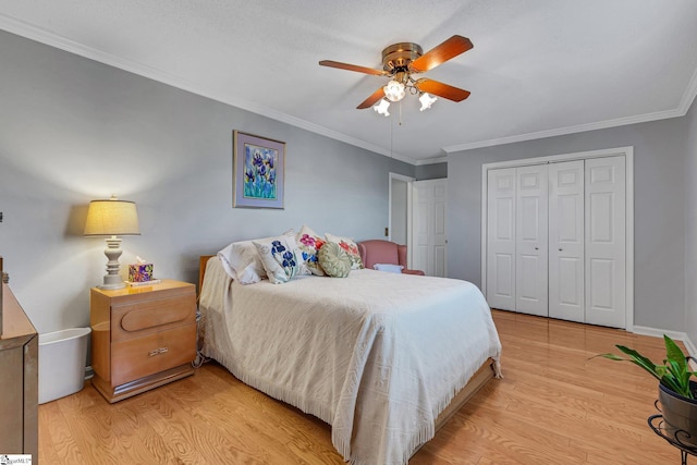 bedroom featuring ornamental molding, light wood finished floors, and a closet