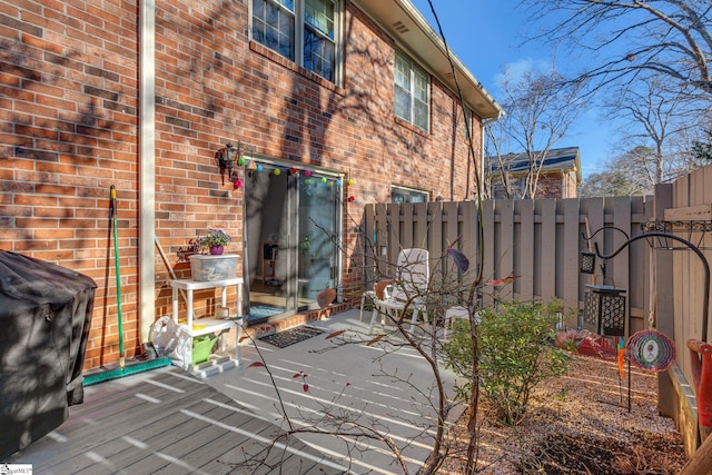 exterior space with brick siding, a patio, and a fenced backyard