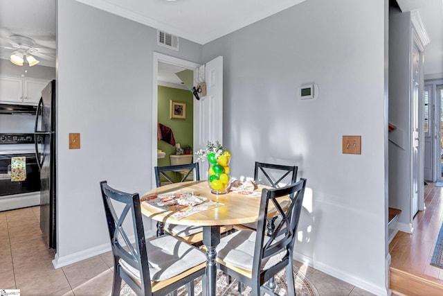 dining area with light tile patterned floors, visible vents, and baseboards