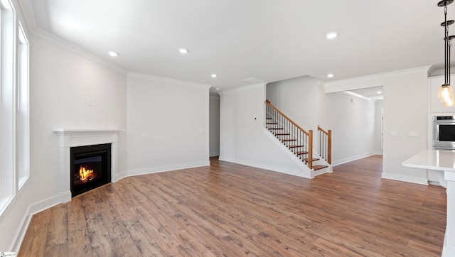 400 Fiery Rd Lot 0173, Mauldin, SC 29607 - unfurnished living room with stairs, a lit fireplace, crown molding, wood finished floors, and recessed lighting