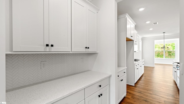 400 Fiery Rd Lot 0173, Mauldin, SC 29607 - kitchen featuring backsplash, white cabinetry, wood finished floors, light stone countertops, and pendant lighting