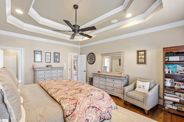 bedroom with a ceiling fan, a raised ceiling, dark wood finished floors, and crown molding