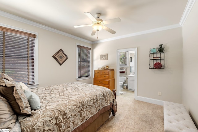 bedroom featuring ornamental molding, light carpet, ensuite bath, and baseboards