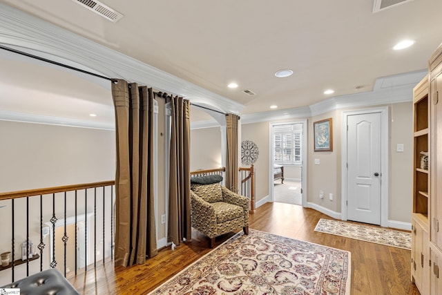 living area with decorative columns, dark wood finished floors, ornamental molding, an upstairs landing, and recessed lighting