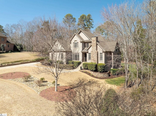 traditional home with brick siding and a front lawn