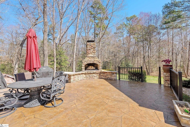 view of patio / terrace with an outdoor stone fireplace