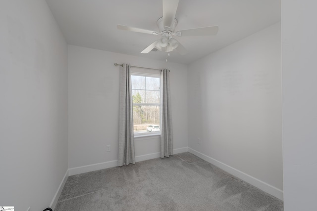 empty room featuring baseboards, ceiling fan, and light colored carpet