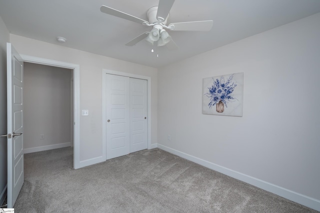 unfurnished bedroom featuring light carpet, a closet, and baseboards