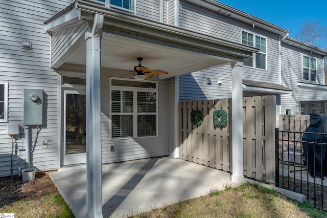 exterior space featuring a patio area, ceiling fan, and fence