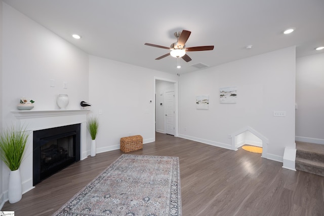 unfurnished living room featuring recessed lighting, dark wood-style flooring, a fireplace, visible vents, and baseboards