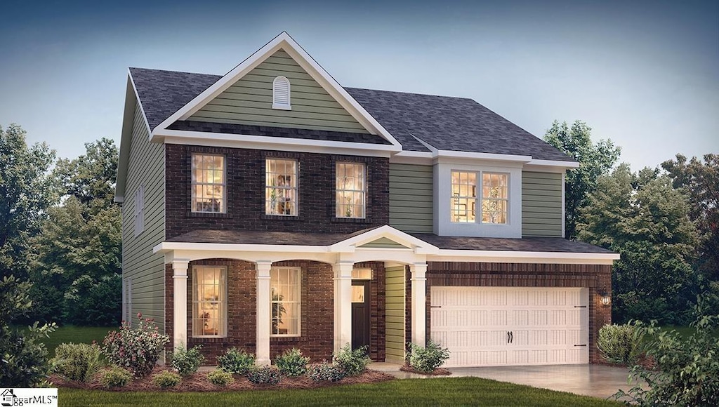 traditional-style house with an attached garage, concrete driveway, and brick siding