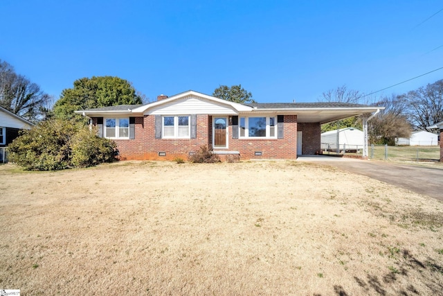 ranch-style house with brick siding, crawl space, fence, an attached carport, and driveway