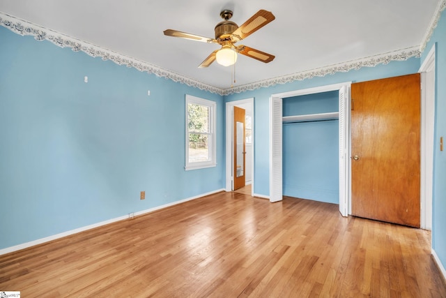 unfurnished bedroom with light wood finished floors, a ceiling fan, baseboards, and a closet