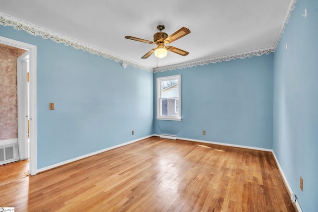 empty room with light wood finished floors, visible vents, baseboards, a baseboard radiator, and ceiling fan