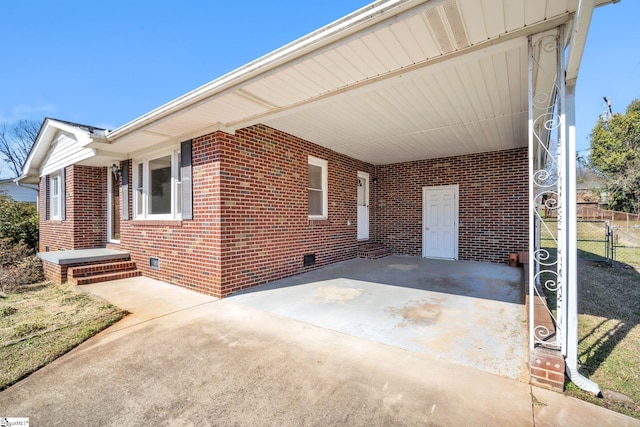 view of patio / terrace with driveway and a carport