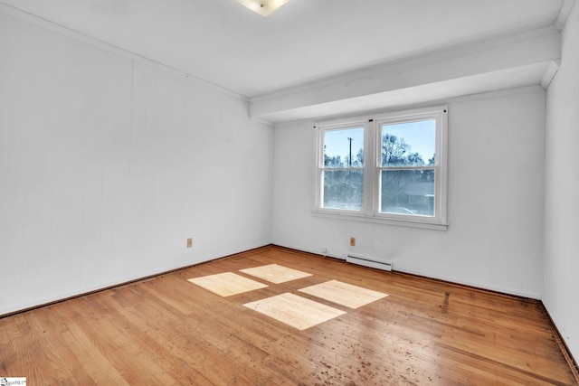 empty room featuring a baseboard radiator and light wood-style floors