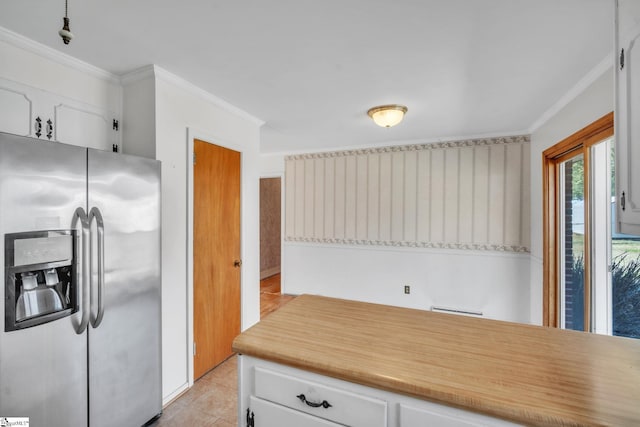 kitchen featuring crown molding, light countertops, stainless steel refrigerator with ice dispenser, and white cabinets