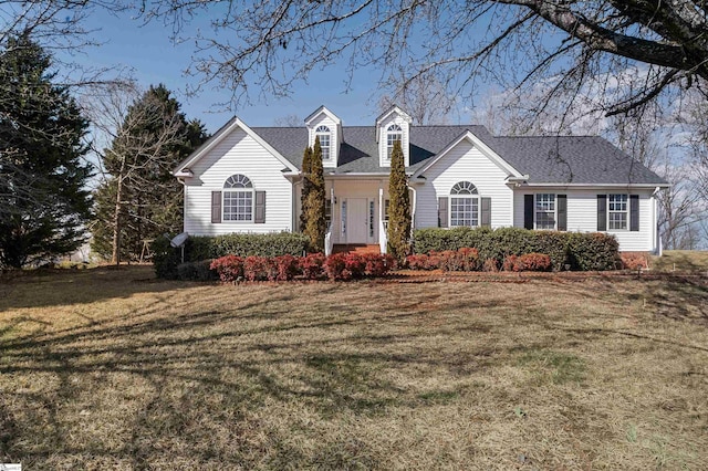 view of front of house with a front lawn and roof with shingles