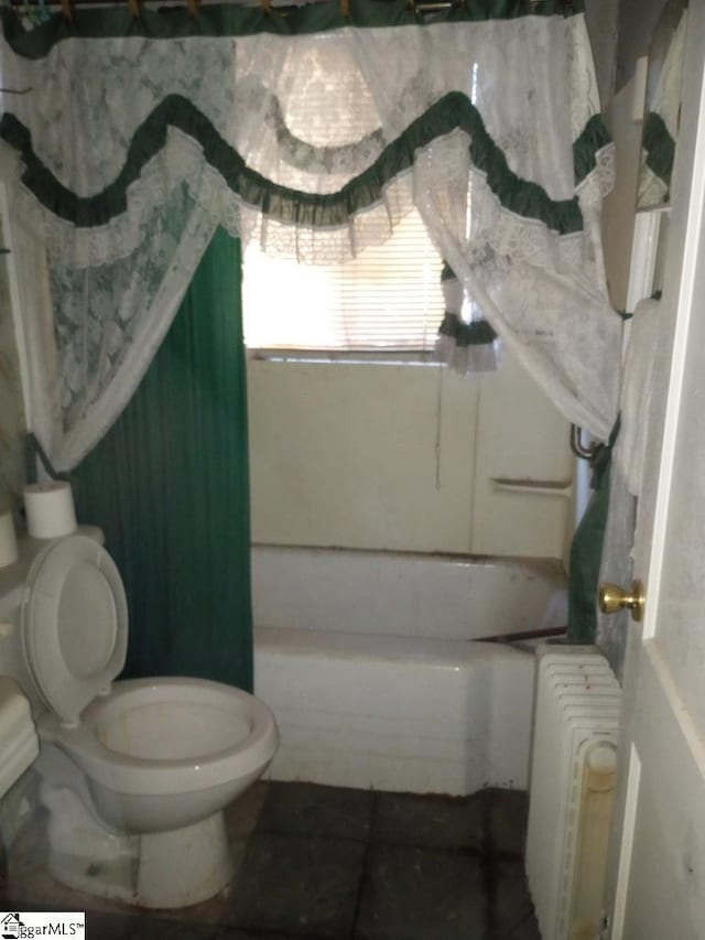 bathroom featuring toilet and radiator heating unit