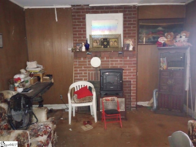 living area featuring wood walls and carpet