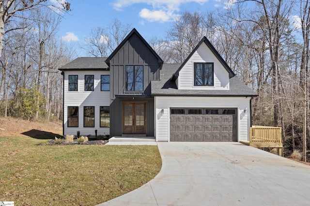 modern inspired farmhouse with a garage, concrete driveway, french doors, board and batten siding, and a front yard