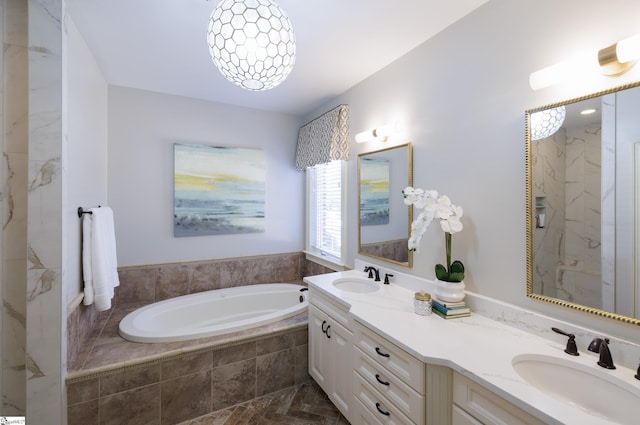 full bath featuring a garden tub, double vanity, and a sink