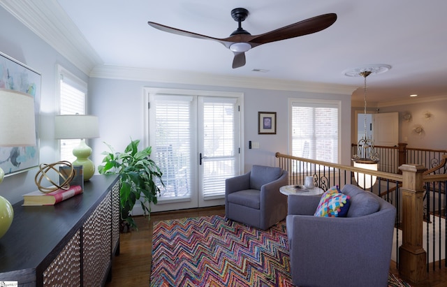 living room featuring ornamental molding, a healthy amount of sunlight, and dark wood-style floors