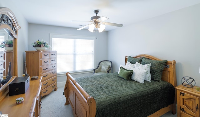 bedroom with light carpet and a ceiling fan