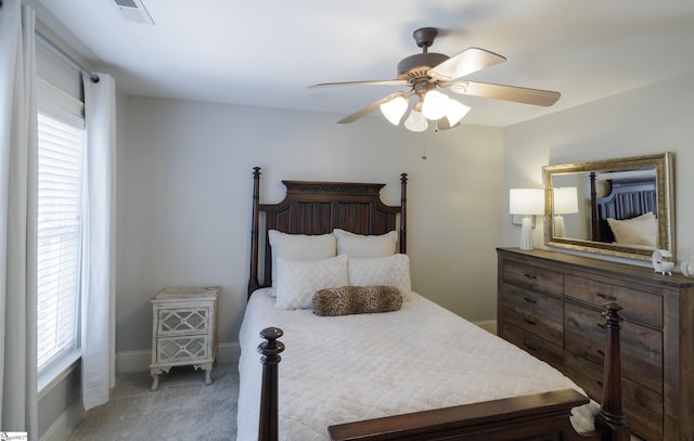 bedroom with a ceiling fan, baseboards, visible vents, and carpet flooring