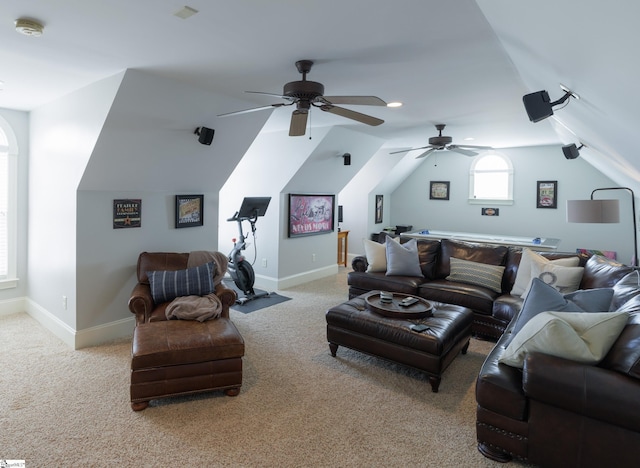 living room with vaulted ceiling, baseboards, a ceiling fan, and light colored carpet