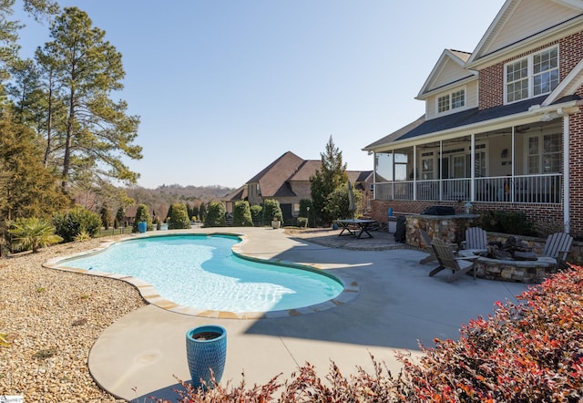 pool with a ceiling fan, an outdoor fire pit, and a patio