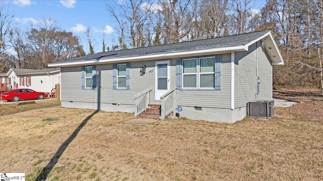 view of front of home with entry steps, crawl space, a front lawn, and central air condition unit