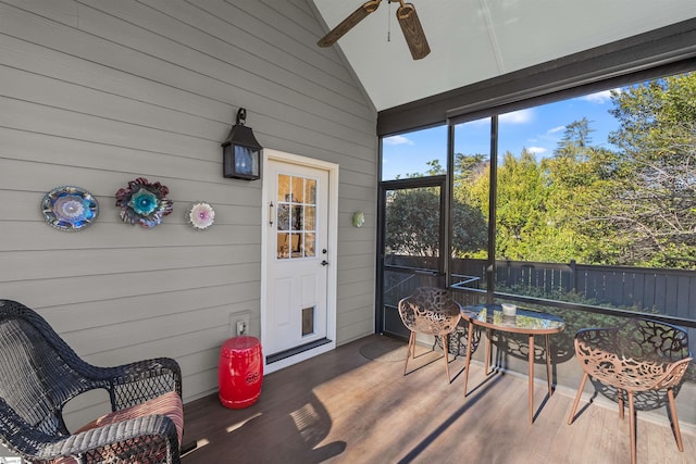 sunroom / solarium with lofted ceiling and a ceiling fan