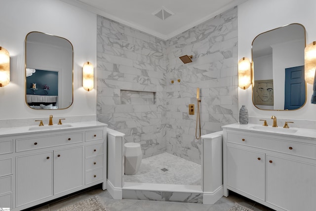 ensuite bathroom featuring marble finish floor, walk in shower, a sink, and visible vents